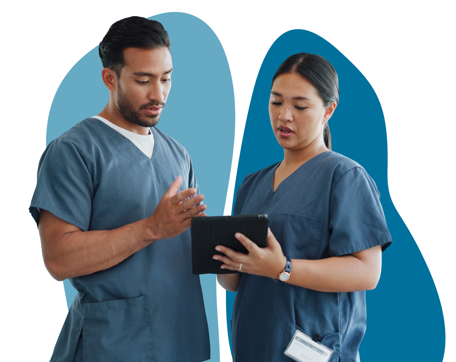 2 doctors dressed in blue tabbards look at a document on a digital device